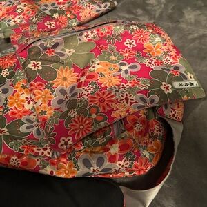 Multi color diaper bag with flowers comes with changing mat. Very good condition